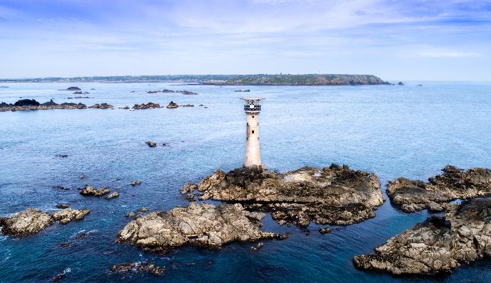 watch tower on island under blue skies